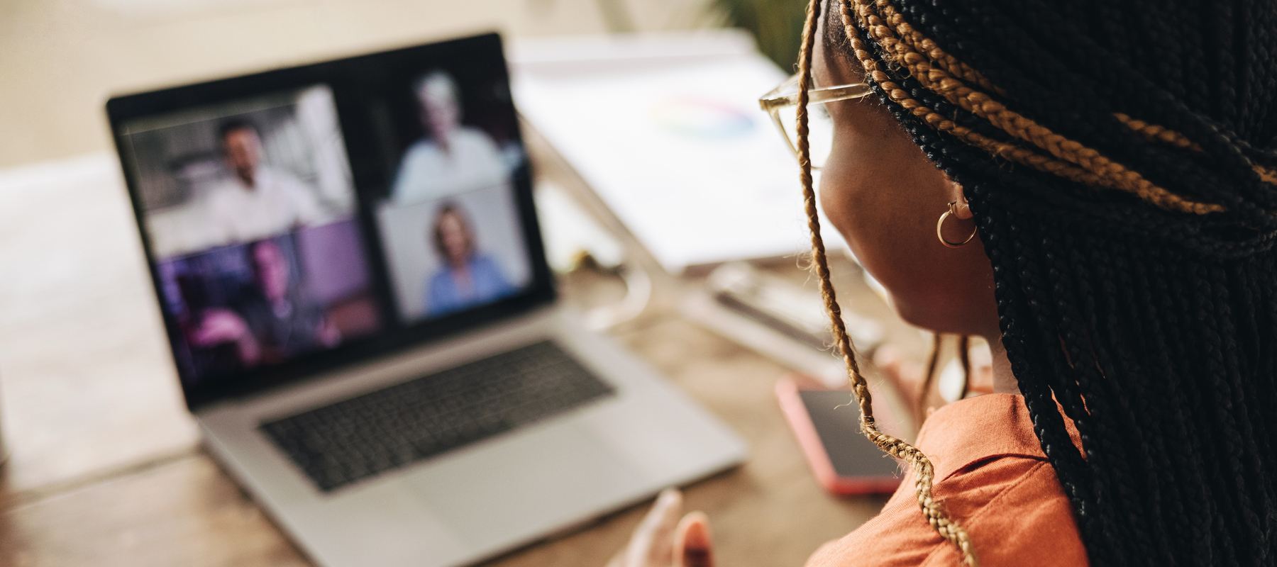 Woman sitting at a computer on a virtual call