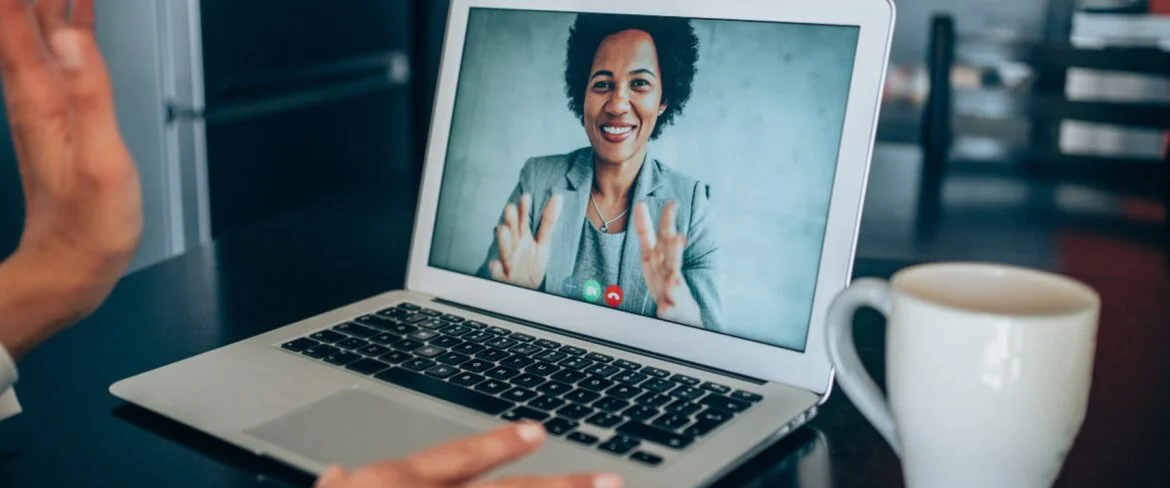 Woman on video call, talking to viewer.